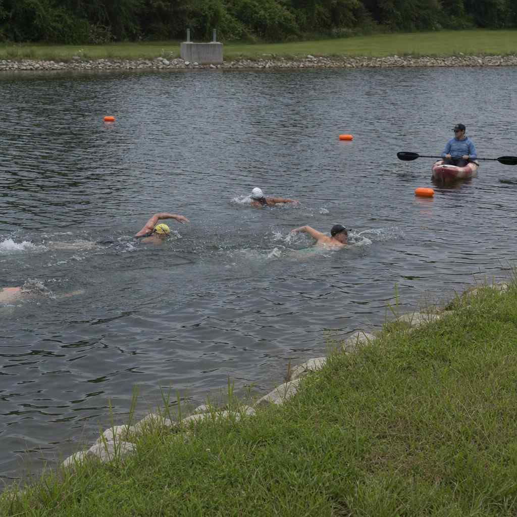 a small supervised open-water swim practice session with marker buoys and a watching kayak